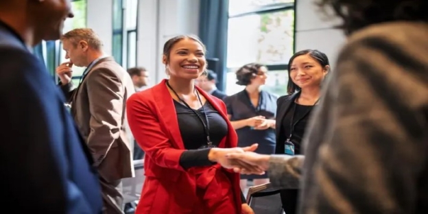 A group of people shaking hands AI-generated content may be incorrect.